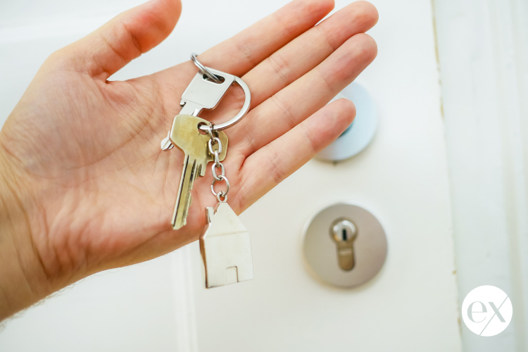 hand-holding-house-keys-real-estate-after-divorce